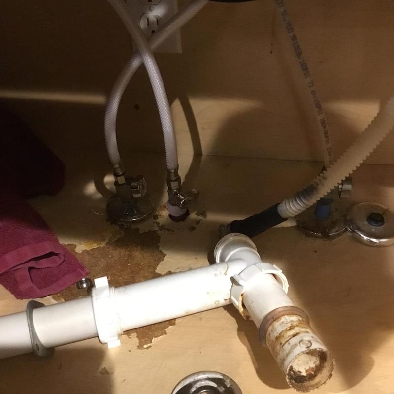 Angle stop valve under kitchen sink with water damage