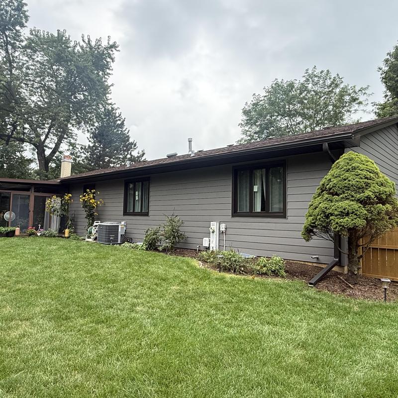 Composite insulated siding and new windows on house exterior