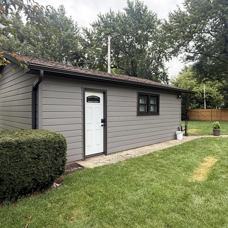 Composite insulated siding and windows on outbuilding