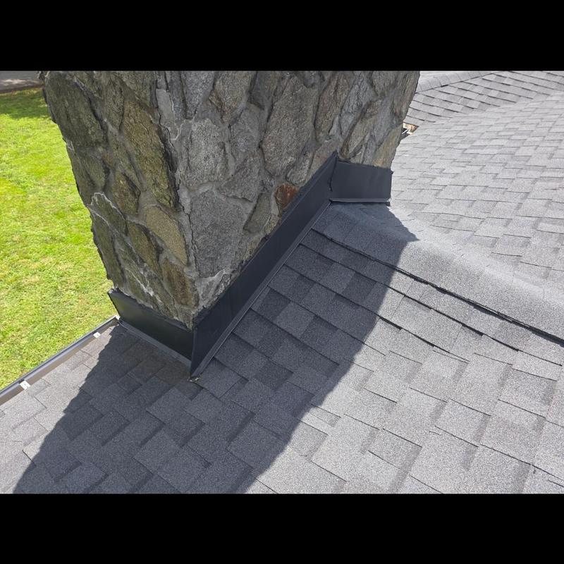 Chimney roof flashing on asphalt shingle roof Chimney roof flashing on asphalt shingle roof