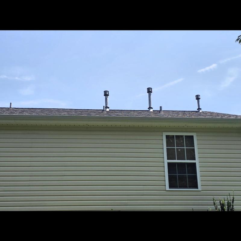 Roof pipe boots on shingled roof in daylight Roof pipe boots on shingled roof in daylight