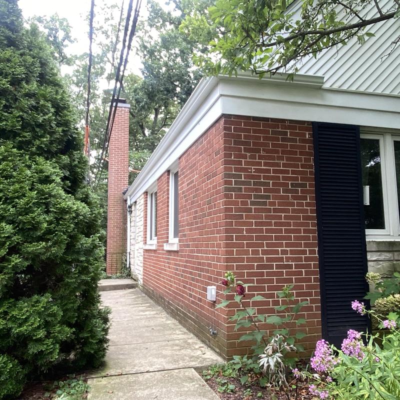 Atlas impact class 4 roof and white gutters on brick house