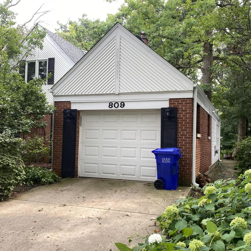 Gutter system on brick garage with driveway