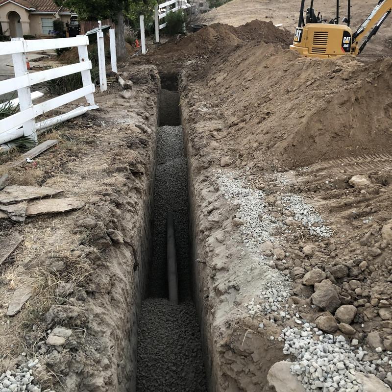 Leach line piping installation with gravel bed trench