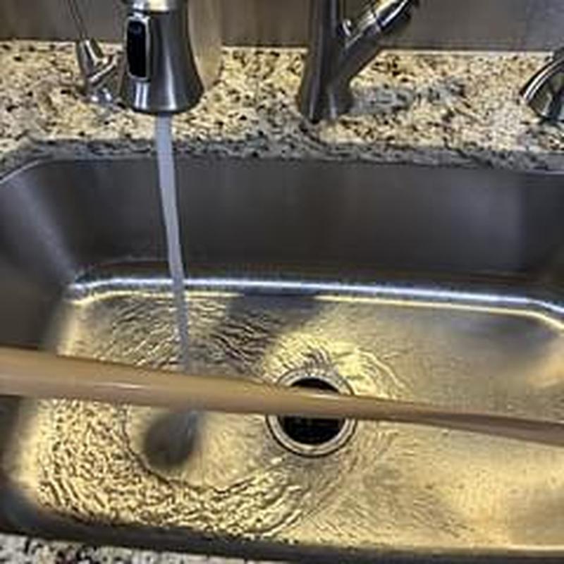 Kitchen sink drain clearing with running water flow Kitchen sink drain clearing with running water flow