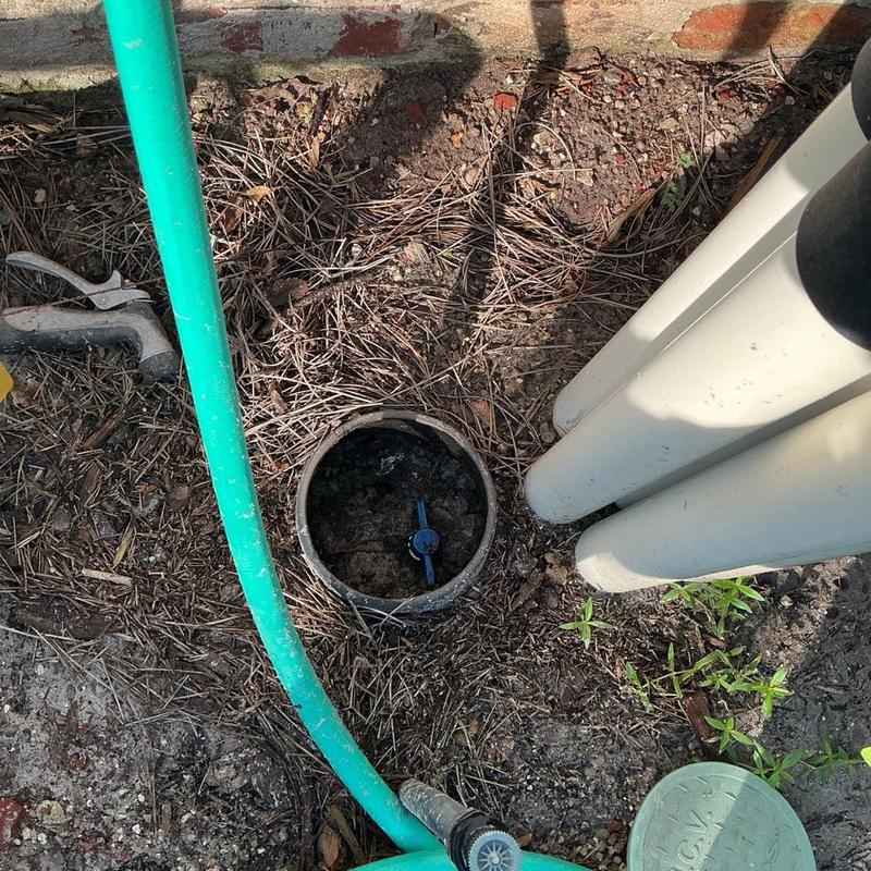 Toilet fill valve inside valve box with green hose nearby Toilet fill valve inside valve box with green hose nearby
