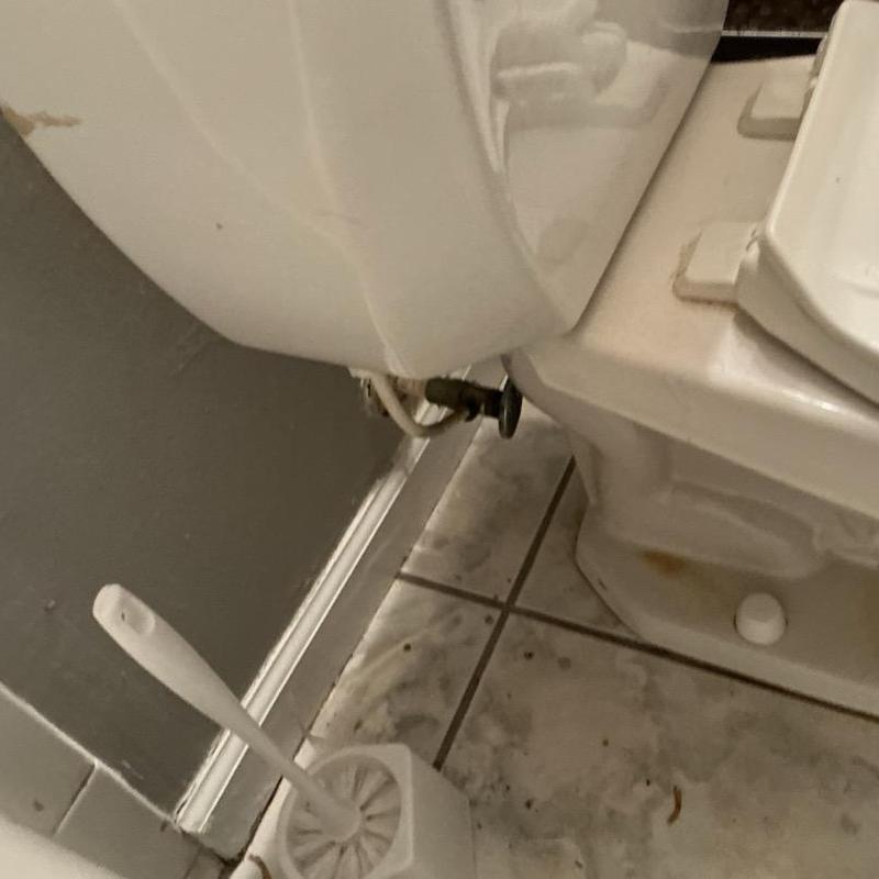 Toilet water supply valve and base on tiled floor Toilet water supply valve and base on tiled floor