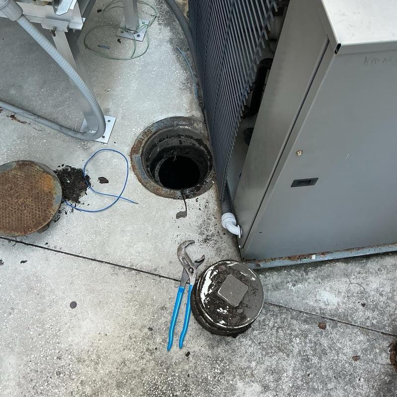 Sewer cleanout with cable and plumbing tools nearby Sewer cleanout with cable and plumbing tools nearby