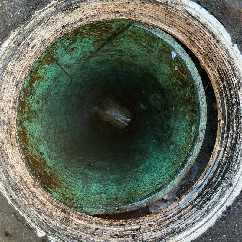 Sewer cleanout pipe interior with rust and debris Sewer cleanout pipe interior with rust and debris