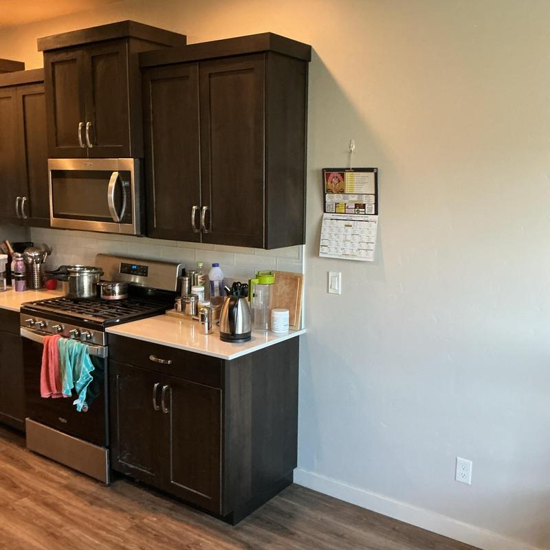 Gas range with dark wood kitchen cabinets and countertop Gas range with dark wood kitchen cabinets and countertop
