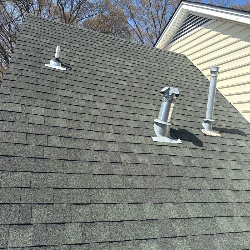 Asphalt shingle roof with vent pipes and flashing