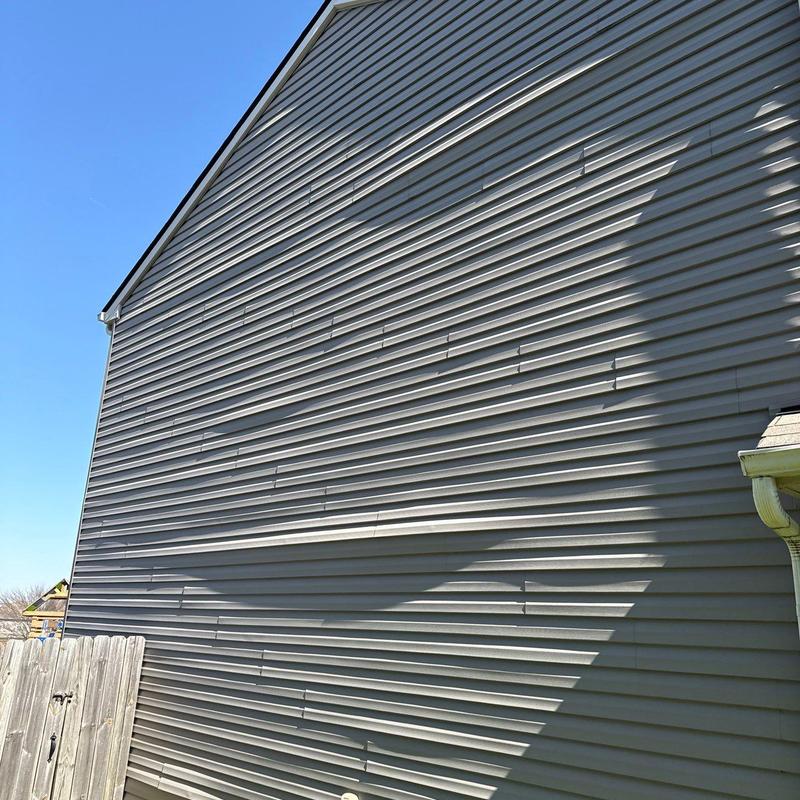 Vinyl siding with visible warping and damage