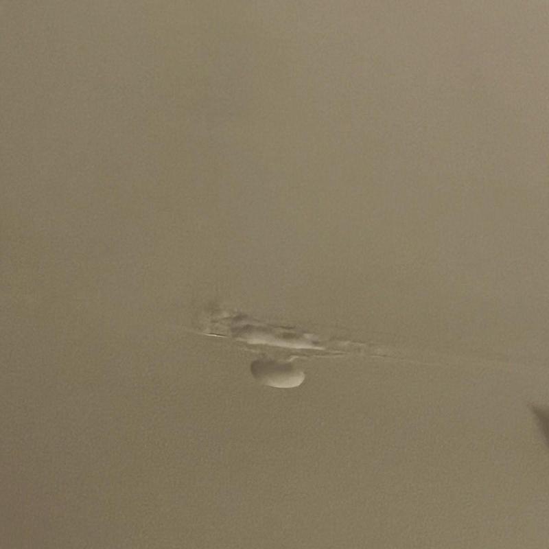 Ceiling drywall with water damage and bubbling paint