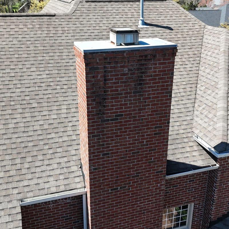 Brick chimney on asphalt shingle roof in Brentwood