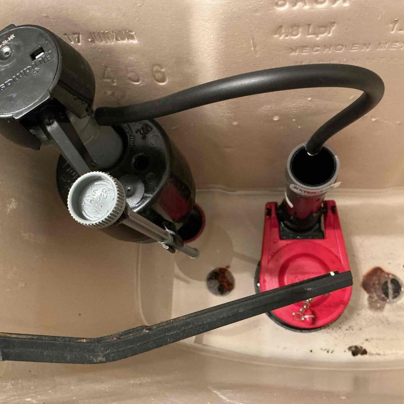 Toilet fill valve and flapper assembly inside tank