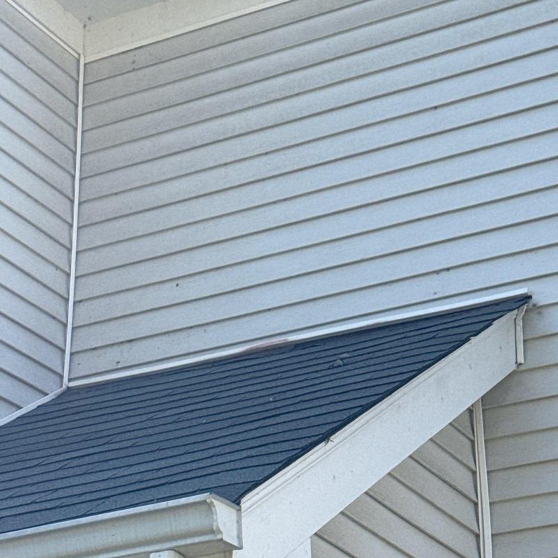 Shingles and flashing on sloped roof section