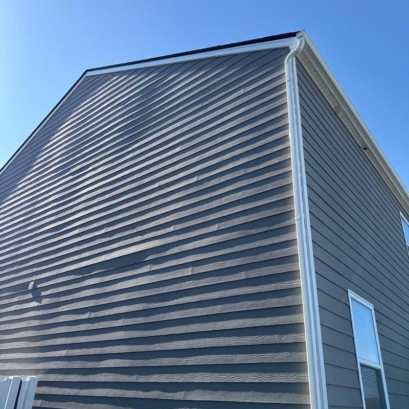 Vinyl siding and gutter installation on house exterior