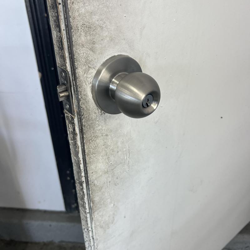 Entry door knob lock on worn white door Entry door knob lock on worn white door