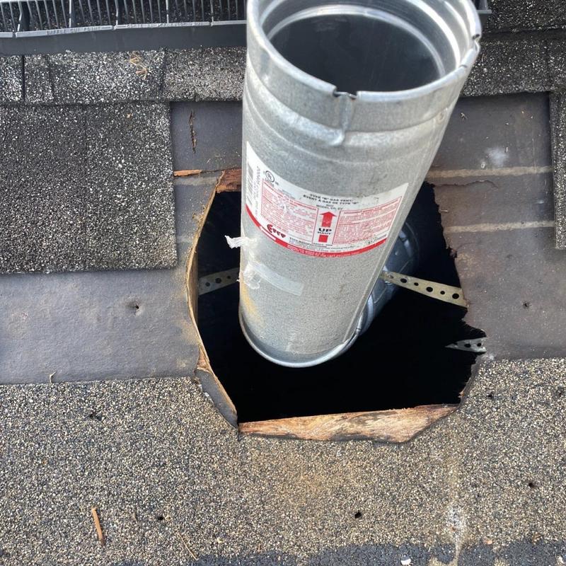 Roof ventilation pipe with damaged surrounding shingles