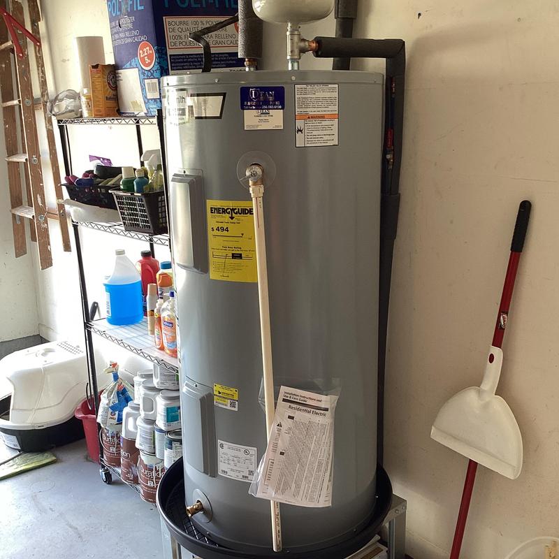 Electric water heater installation in garage with expansion tank