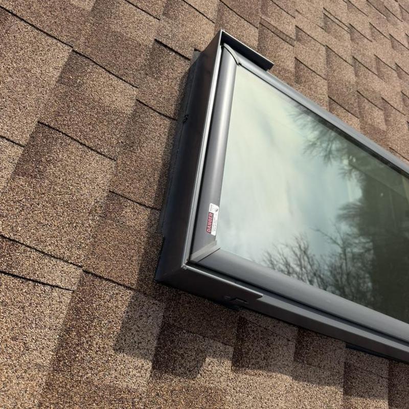 Roof skylight installation on shingle roof close-up Roof skylight installation on shingle roof close-up