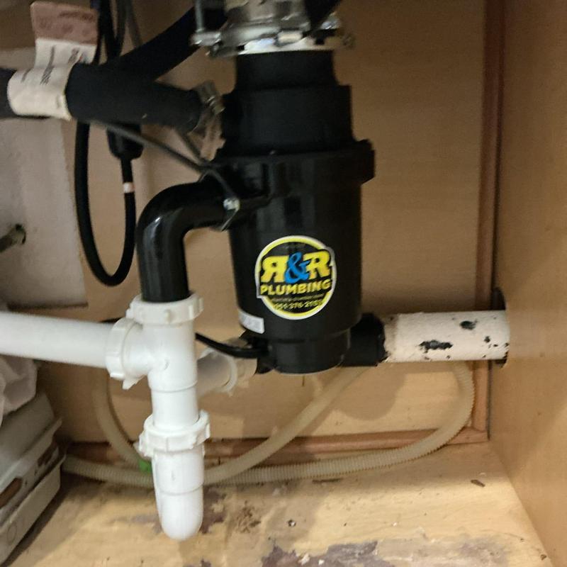 Garbage disposal unit and drain pipes under sink