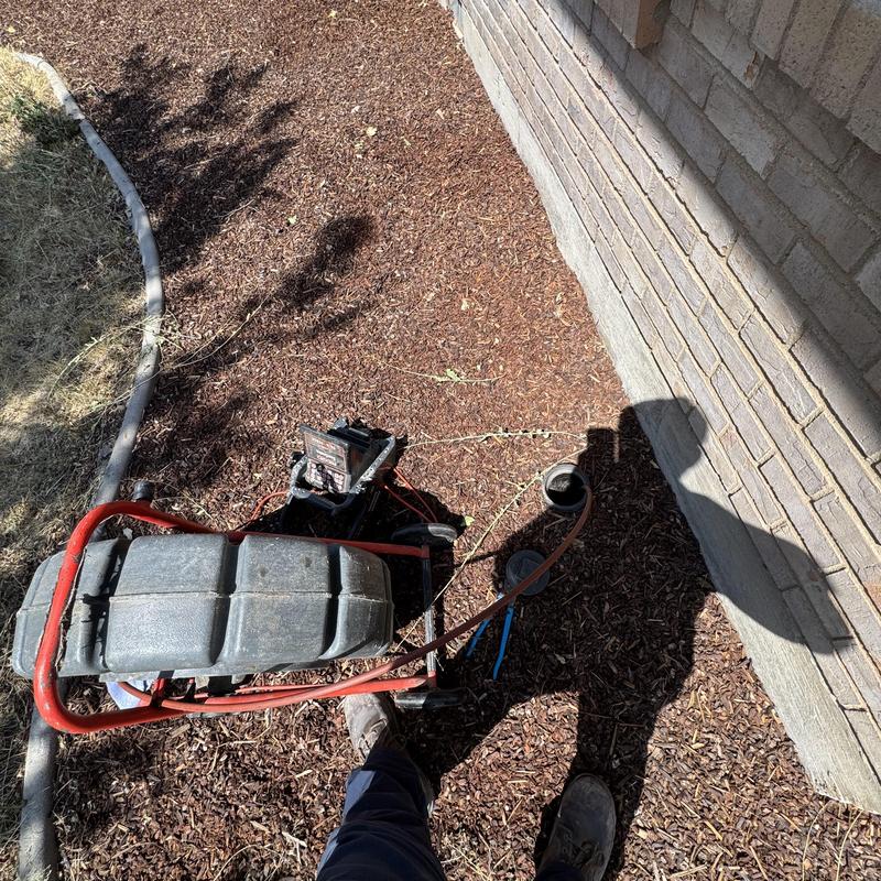 Sewer line inspection with drain snake near house wall Sewer line inspection with drain snake near house wall
