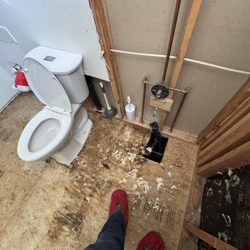 Toilet flange and plumbing rough-in with flooring damage Toilet flange and plumbing rough-in with flooring damage