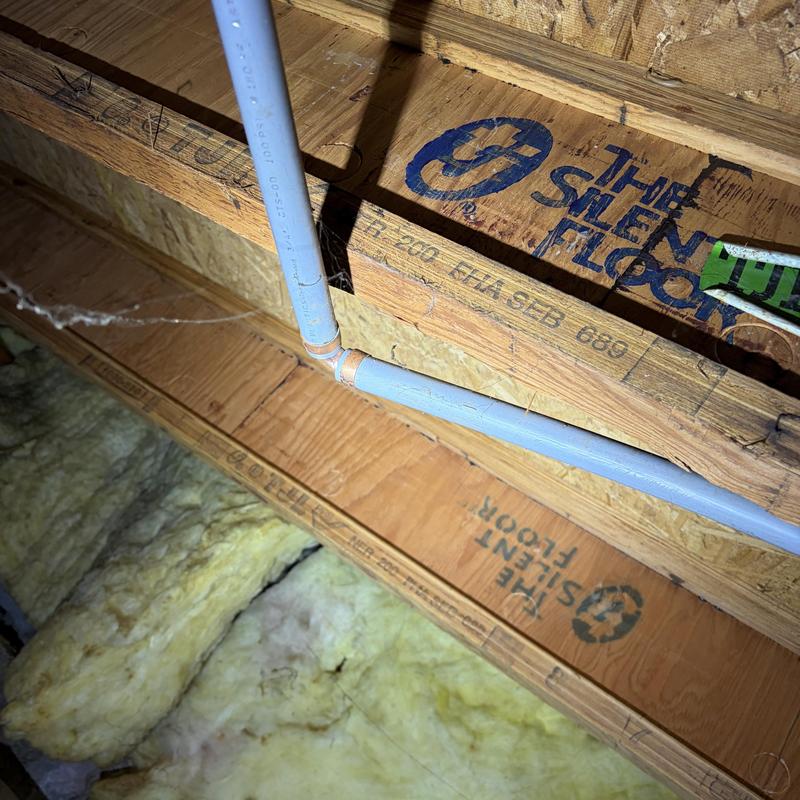 Polybutylene water pipe with copper fitting in attic Polybutylene water pipe with copper fitting in attic