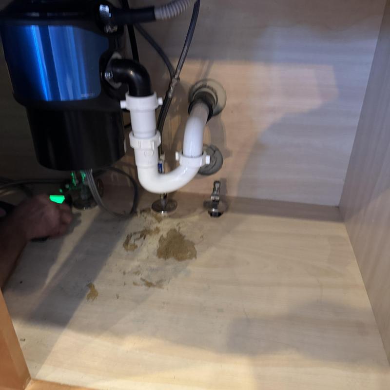 Kitchen sink drain pipes with water staining under cabinet Kitchen sink drain pipes with water staining under cabinet