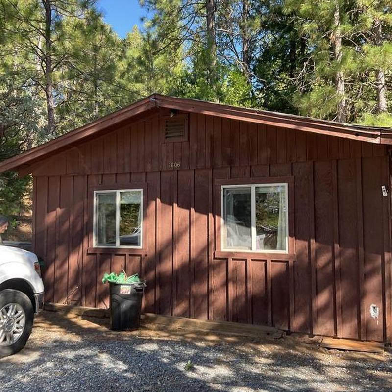 Torch down roof installation on rustic cabin exterior