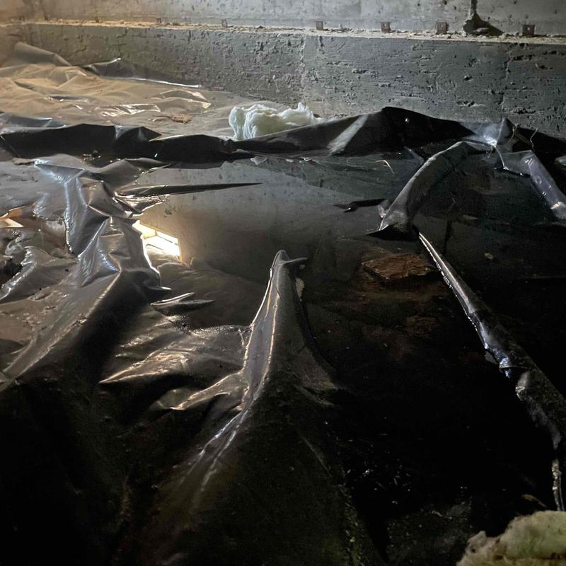 Crawl space moisture with damaged vapor barrier plastic