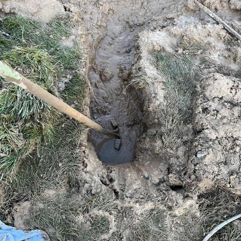 Main water line trench with hand digging tool