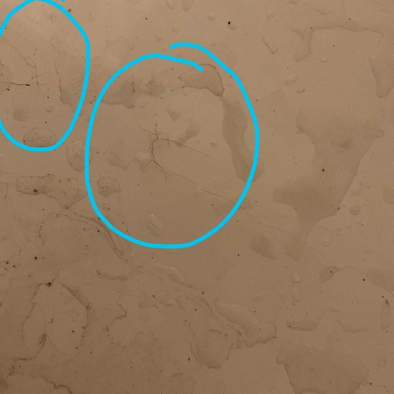Bathtub surface cracks and water stains highlighted