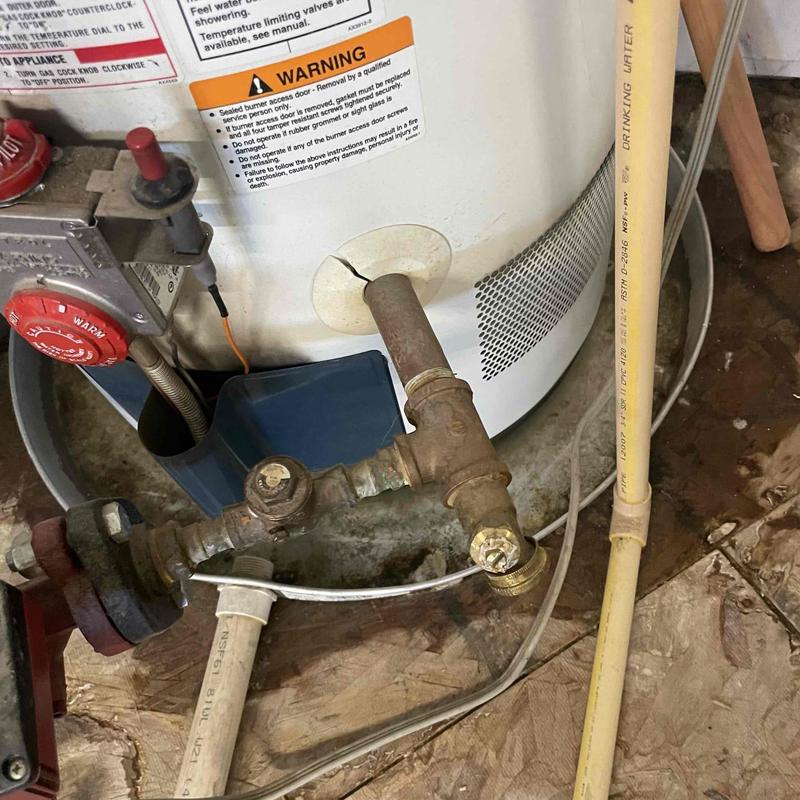Gas water heater pipe and valve connections close-up