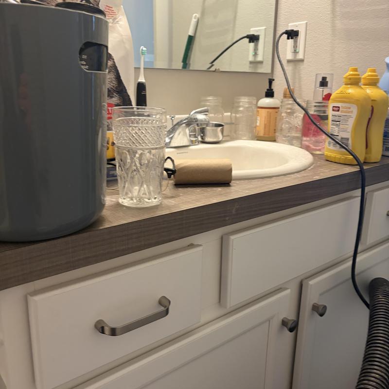 Bathroom sink faucet and countertop with cleaning tools Bathroom sink faucet and countertop with cleaning tools