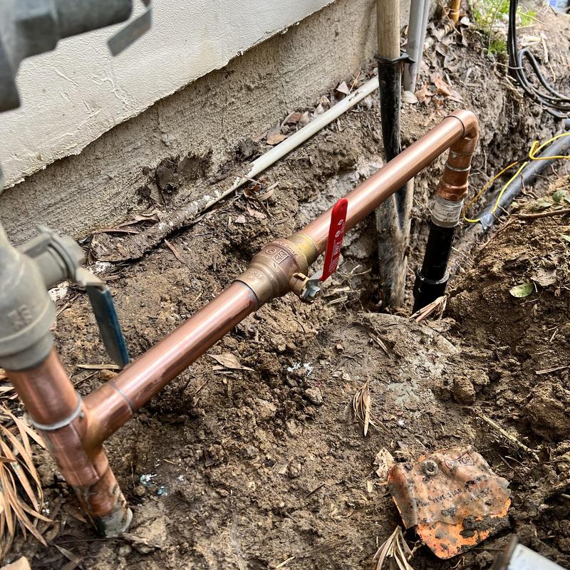 Copper water shutoff valve and piping installation outdoors