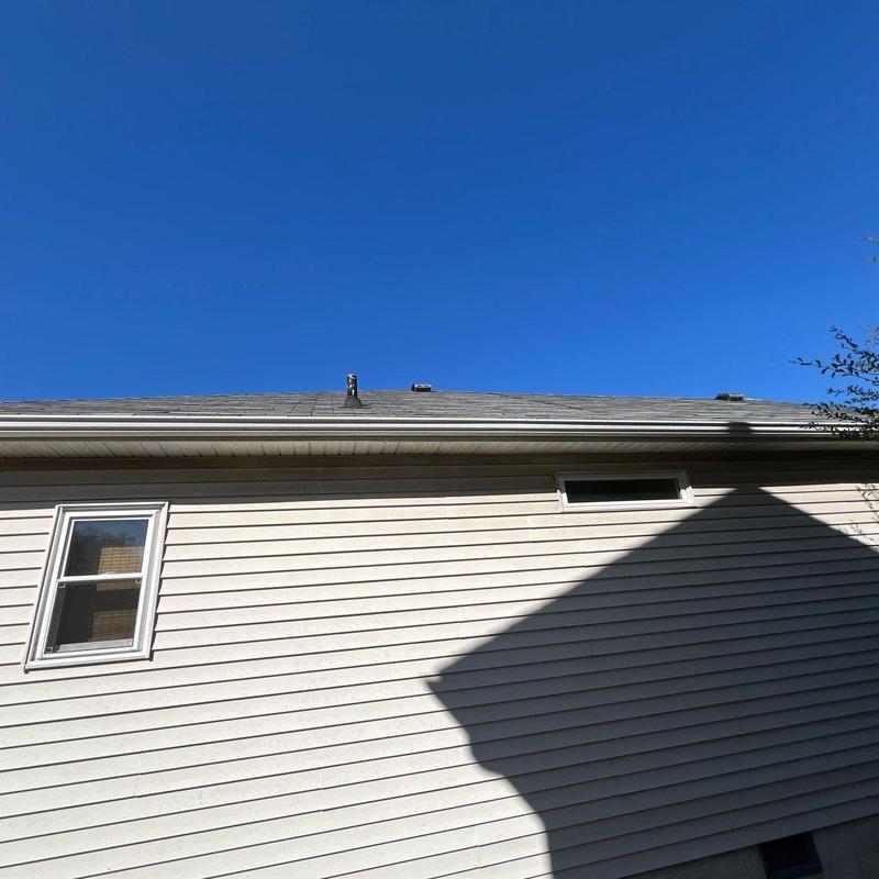 Asphalt shingle roof with hail damage and flashing issues