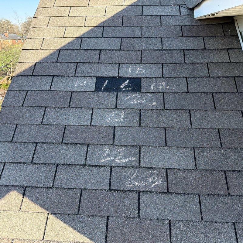 Asphalt roof shingles with hail damage markings