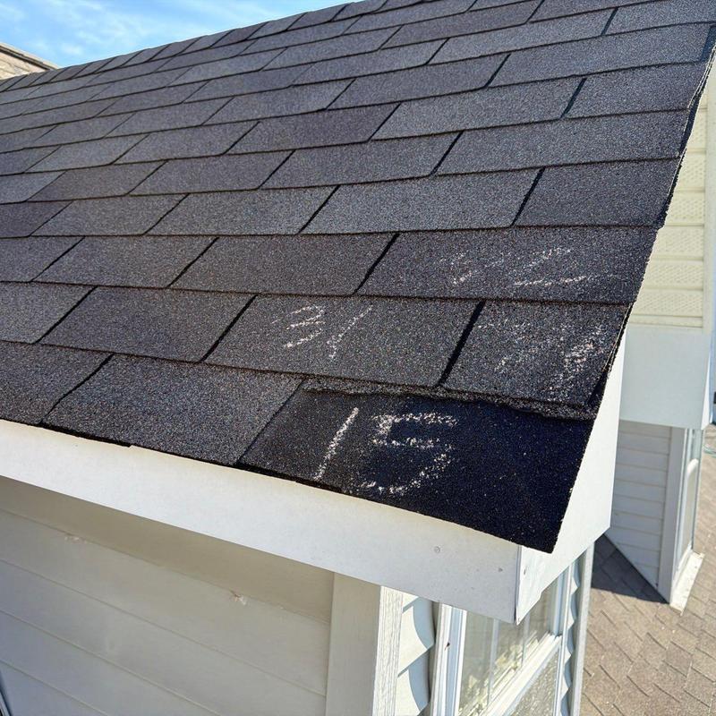 Asphalt shingle roof with hail damage markings