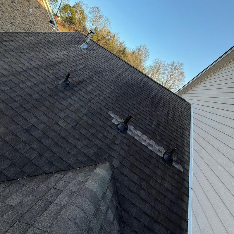 Asphalt shingle roof with vent pipe flashings and damage