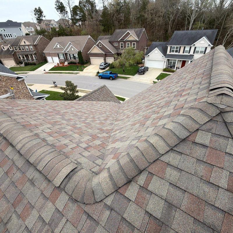 Asphalt shingle roof ridges with visible hail impact