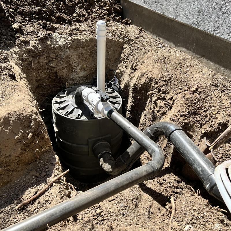 Sewage ejection pump and piping installation in trench