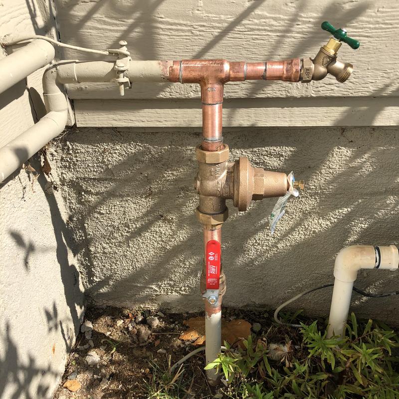 Copper pressure regulator and shut off valve assembly outdoors