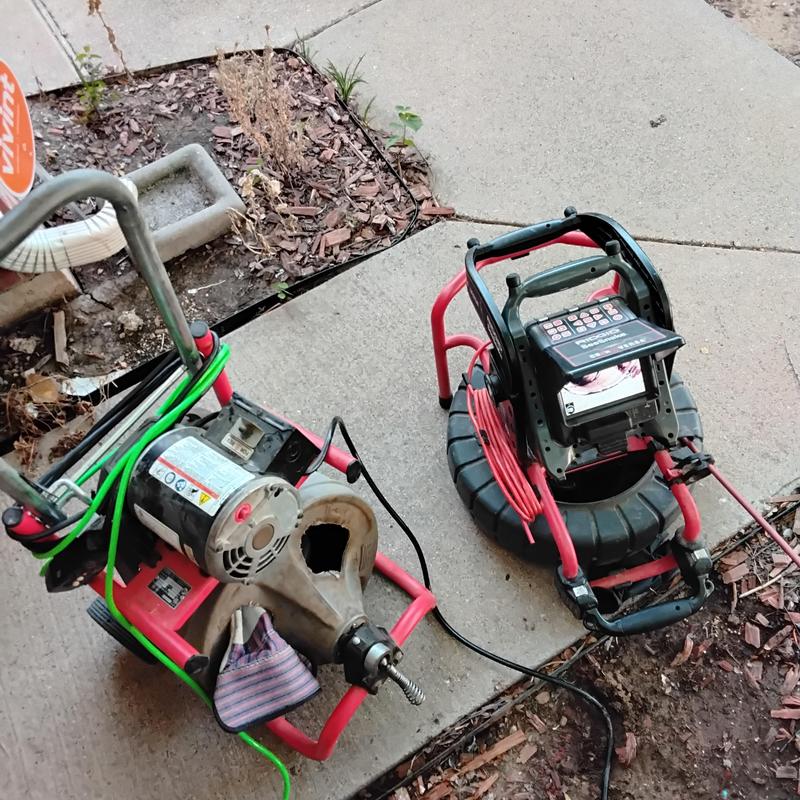 Main sewer line cable and camera equipment on sidewalk
