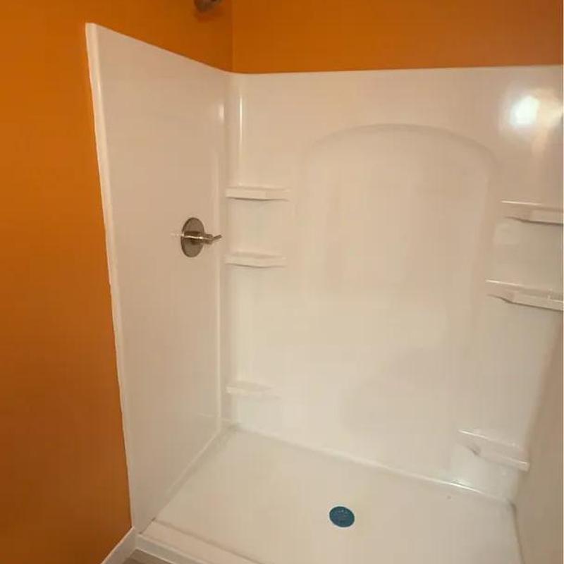 Shower stall with fixtures installed in basement