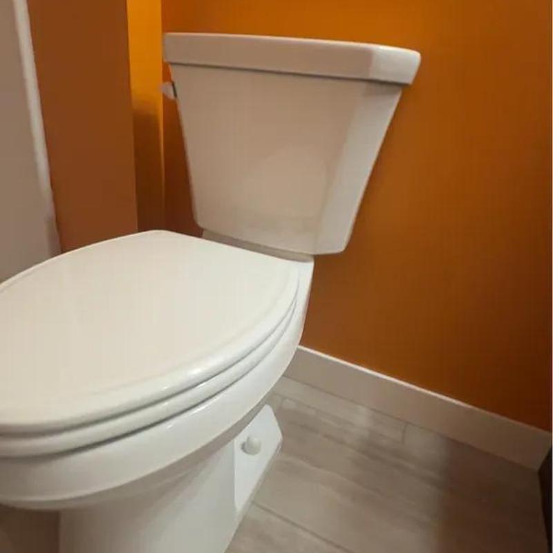 Toilet installation in basement bathroom corner