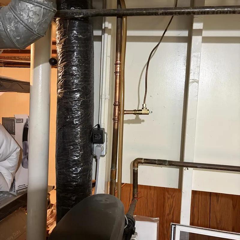 Shutoff valve and copper piping in basement wall
