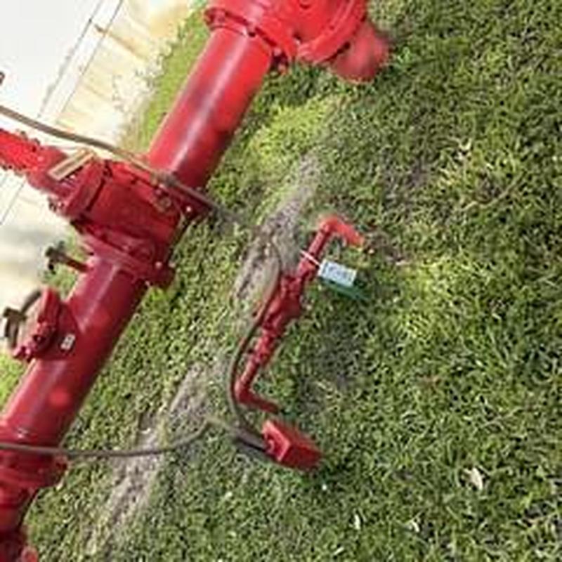 Backflow prevention devices on grassy ground in outdoor area
