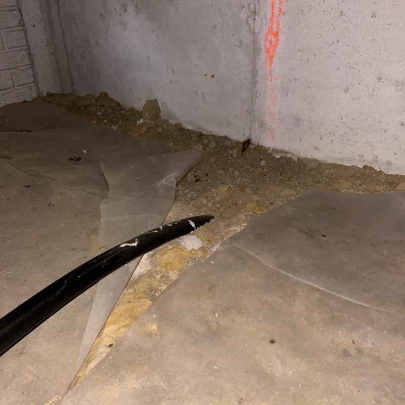 Broken underground water main pipe with exposed soil